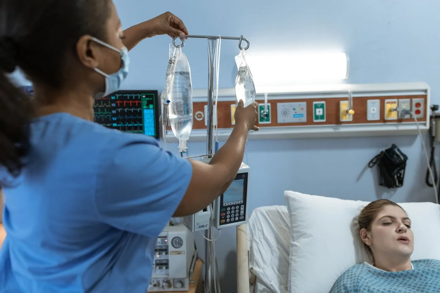 A nurse preparing an IV infusion for a patient at the Cancer Center